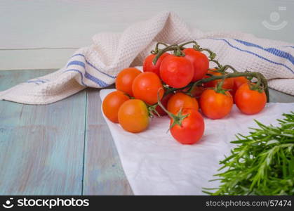 Organic cherry tomatoes with rosemary on wrinkled paper