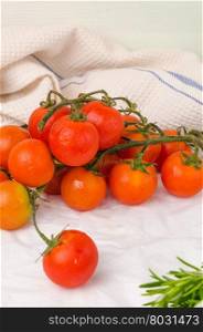 Organic cherry tomatoes with rosemary on wrinkled paper