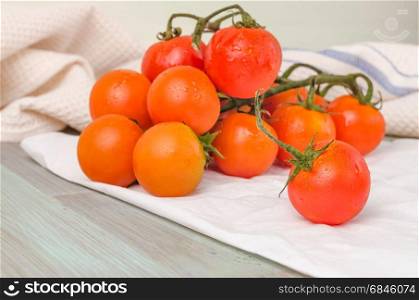 Organic cherry tomatoes with rosemary on wrinkled paper. Top view