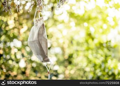 Organic Cotton Face Mask Hanging on Clothesline. Fabric Washable Mask after Wash Cleaning for Reuse