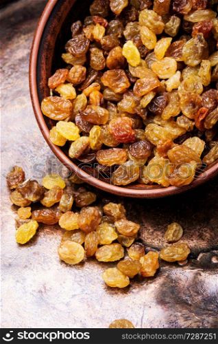 Organic dried golden raisins in a bowl. Ceramic bowl with raisins