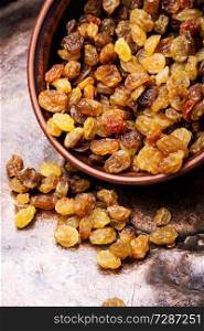 Organic dried golden raisins in a bowl. Ceramic bowl with raisins