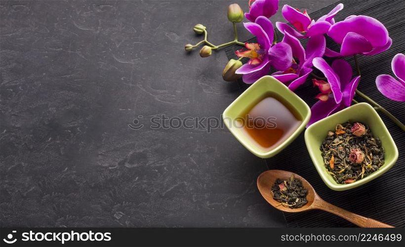 organic dried tea herb pink orchid flower black background