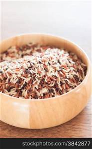 Organic Dry Multi Grain Rice in wooden bowl, stock photo
