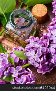Organic essential aroma oil with lilac. Bottle of essential oil with lilac.Healing herbs.Natural organic extraction