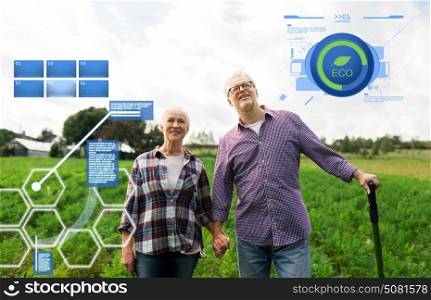 organic farming, agriculture and people concept - happy senior couple at summer farm. happy senior couple at summer farm