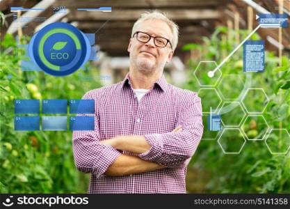 organic farming, agriculture and people concept - happy senior man at farm greenhouse. happy senior man at farm greenhouse
