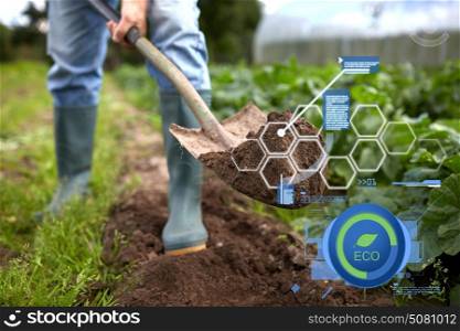 organic farming, agriculture and people concept - man with shovel digging garden bed or farm. man with shovel digging garden bed or farm