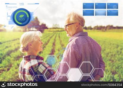 organic farming, gardening, agriculture and people concept - happy senior couple at summer farm. happy senior couple at summer farm. happy senior couple at summer farm