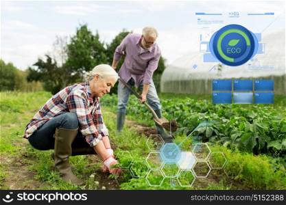 organic farming, gardening, agriculture and people concept - happy senior couple working in garden at summer farm. senior couple working in garden or at summer farm