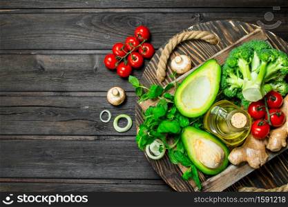 Organic food. Assortment of ripe vegetables in a wooden box. On a wooden background.. Organic food. Assortment of ripe vegetables in a wooden box.