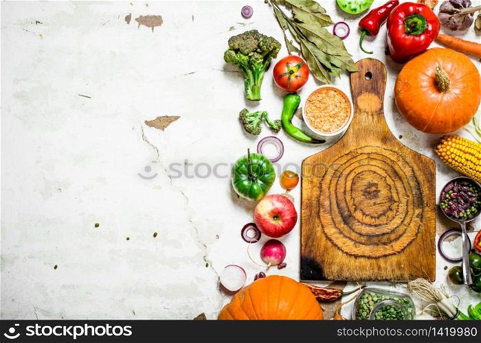 Organic food. Cutting Board with vegetables and herbs. On rustic background .. Organic food. Cutting Board with vegetables and herbs.