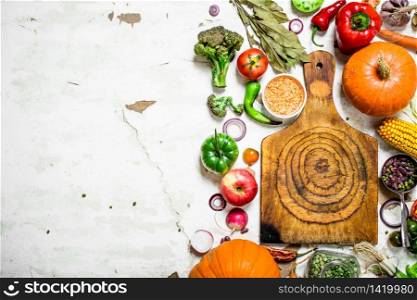 Organic food. Cutting Board with vegetables and herbs. On rustic background .. Organic food. Cutting Board with vegetables and herbs.