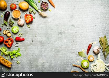 Organic food. Fresh slices of vegetables with spices. On the stone table.. Organic food. Fresh slices of vegetables with spices.