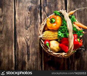 Organic food . Fresh vegetables in the old basket. On wooden background.. Organic food . Fresh vegetables in the old basket.