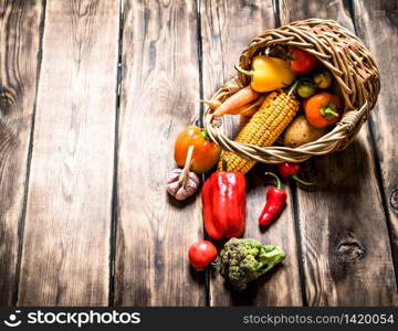 Organic food . Fresh vegetables in the old basket. On wooden background.. Organic food . Fresh vegetables in the old basket.