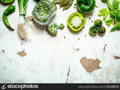 Organic food. Green vegetables with dried peas. On rustic background .. Organic food. Green vegetables with dried peas.