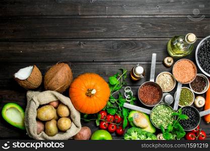 Organic food. Healthy assortment of vegetables and fruits with legumes. On a wooden background.. Organic food. Healthy assortment of vegetables and fruits with legumes.