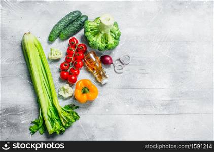 Organic food. Ripe vegetables with olive oil. On a rustic background.. Organic food. Ripe vegetables with olive oil.
