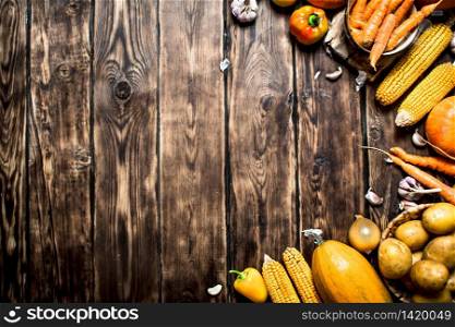 Organic food. Yellow autumn vegetables . On wooden background. Yellow autumn vegetables .