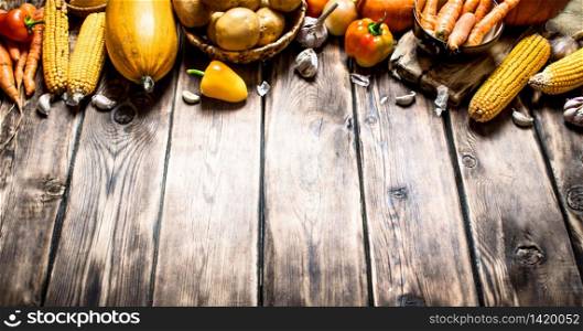 Organic food. Yellow autumn vegetables . On wooden background. Yellow autumn vegetables .