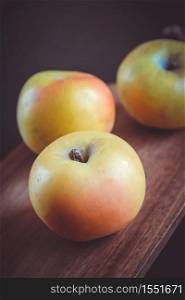 Organic fresh apples on wooden cutting board. Apples on wooden cutting board