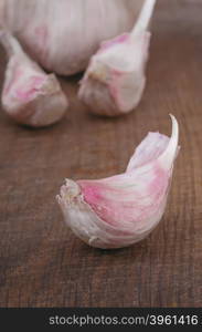 Organic garlic clove on wooden table closeup