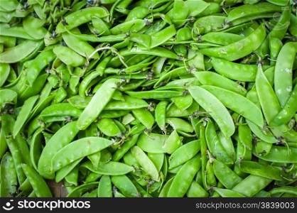 Organic green beans for sale at outdoor asian marketplace. Food background