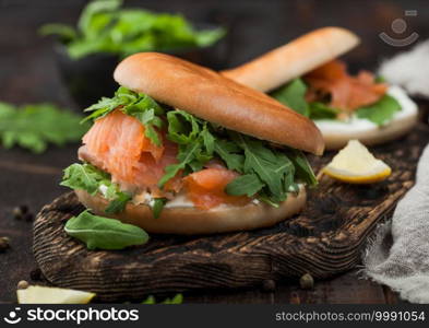 Organic healthy sandwiches with salmon and bagel, cream cheese and wild rocket and lemon and pepper.