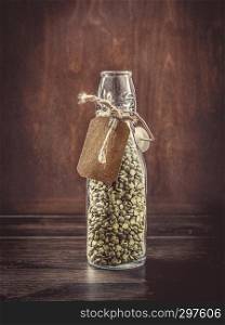 Organic legumes Green peas in a glass bottle
