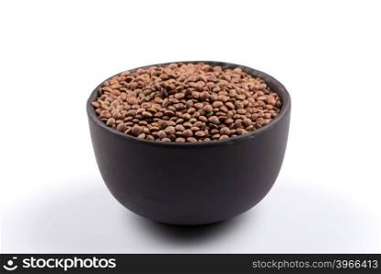 Organic lentils in bowl Isolated on a white background - close up shot