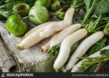 Organic local daikon radish and eggplant vegetables for sale at outdoor asian marketplace