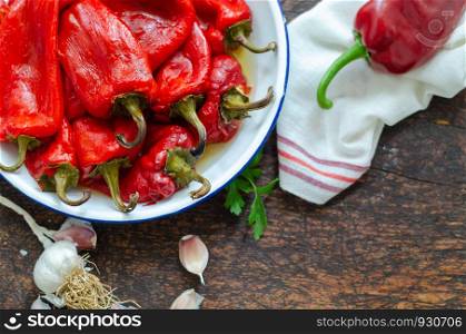 Organic Marinated Roasted Red Peppers in a Bowl on wooden table.