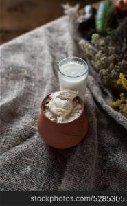 Organic milk and cream. Organic milk and sour cream in vintage dish on rustic background