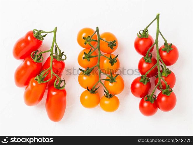 Organic Mini Tomatoes with basil and pepper on stone kitchen background.