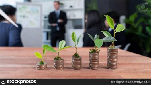 Organic money growth investment concept shown by stacking piles of coin with sprout or baby plant on top. Financial investments rooted and cultivating wealth in harmony with nature. Quaint. Organic money growth investment concept with stacking coin and plant. Quaint