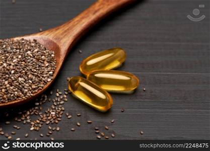Organic natural chia seeds and wooden scoop close-up on wooden background or table. High quality photo. Organic natural chia seeds and wooden scoop close-up on wooden background or table