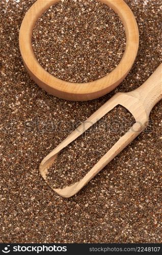 Organic natural chia seeds, wooden scoop and bowl close-up. High quality photo. Organic natural chia seeds, wooden scoop and bowl close-up