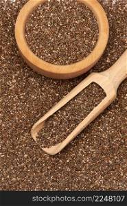 Organic natural chia seeds, wooden scoop and bowl close-up. High quality photo. Organic natural chia seeds, wooden scoop and bowl close-up