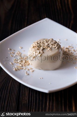 Organic oat dessert with vanilla on the white plate