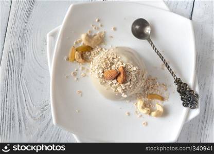 Organic oat dessert with vanilla on the white plate