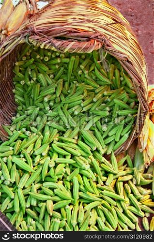 Organic Okra Spilling From A Basket At A Street Market (Lady Fingers)