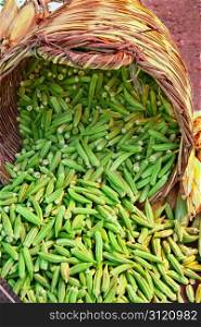 Organic Okra Spilling From A Basket At A Street Market (Lady Fingers)
