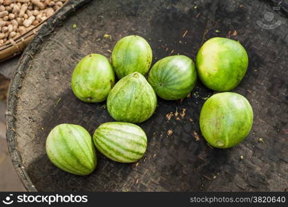 Organic oriental melons for sale at outdoor asian marketplace. Food background