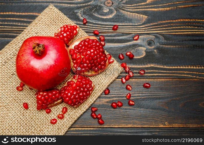 Organic Pomegranate and seeds close-up macro studio shot. Pomegranate and seeds close-up on wooden background