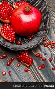 Organic Pomegranate and seeds close-up macro studio shot. Pomegranate and seeds close-up on wooden background