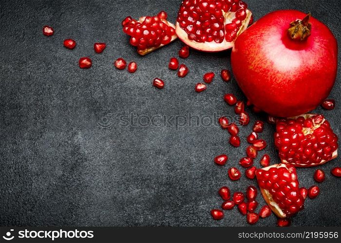 Organic Pomegranate and seeds close-up macro studio shot. Pomegranate and seeds close-up
