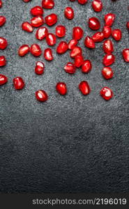 Organic Pomegranate seeds close-up macro studio shot. Pomegranate seeds close-up on dark concrete background