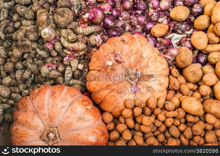 Organic pumpkins, ginger and potato for sale at outdoor asian marketplace. Food background