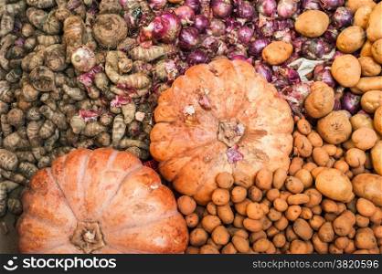 Organic pumpkins, ginger and potato for sale at outdoor asian marketplace. Food background